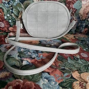 Small, grey cross body purse.